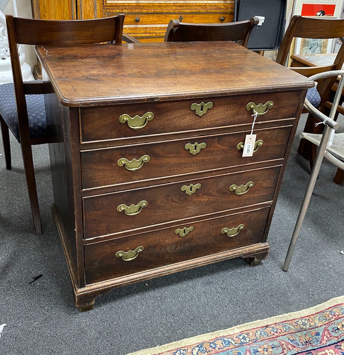 A small George II mahogany chest of drawers of four long drawers, with original brass batwing shaped brass escutcheons and handle back plates, heigth 75cm, width 74.5cm, depth 50cm